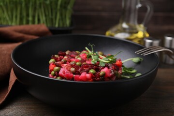 Delicious vinaigrette salad on wooden table, closeup
