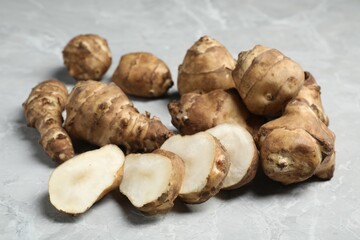 Jerusalem artichokes on light grey marble table, closeup