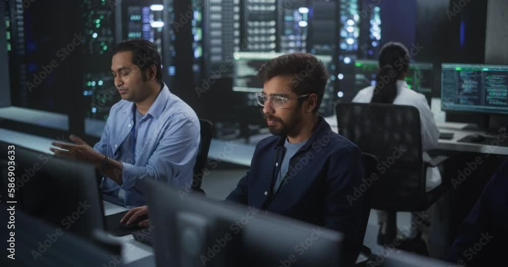 Fototapete Young Colleagues Working on Computers and Having a Conversation at a Workplace. Two Indian Software Developers Discussing a Solution for Their Collaborative Artificial Intelligence Project