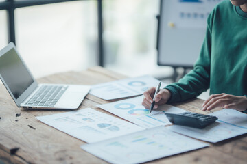 Financial Businesswomen analyze the graph of the company's performance to create profits and growth, Market research reports and income statistics, Financial and Accounting concept.