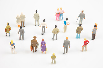 miniature people. different people stand on a white background. communication of society of...