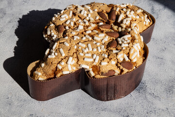 Colomba pastries with hard shadows on a stone table. Italian traditional food with hard shadows