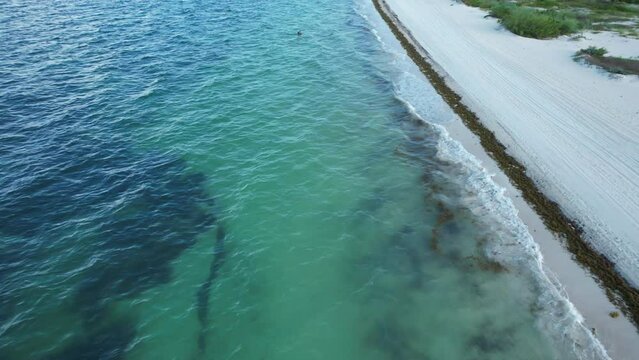 Flying over the waters and sand bar of the Gulf of Mexico. Located in Cancun, Mexico. Aerial 4K drone video