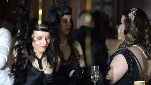 Vintage retro Great gatsby young women dancing drinking champagne on a vintage party, throwback retro roaring twenties concept
