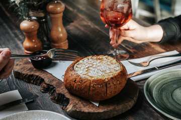 Cocktail with baked camembert on table