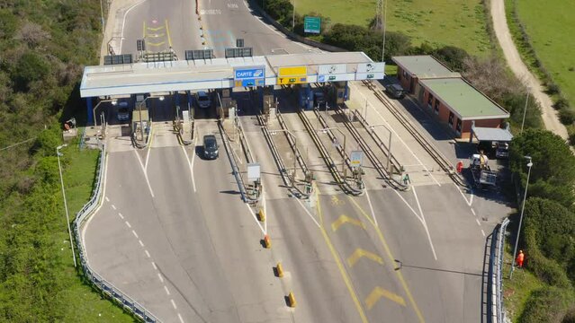 Aerial view of an Italian highway toll booth. There are lanes for paying the toll by debit card, cash or telepass.