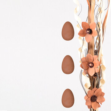 Creative layout made with flower arrangement and a branch. Easter eggs. Minimal nature background. Spring holidays concept.