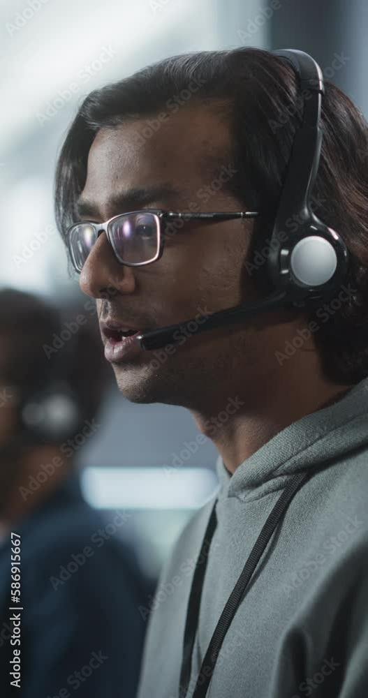 Fototapete Vertical Screen: Help Desk Specialist Having a Conversation on a Call, Providing Technical Support to Client Experiencing Software Issues. Indian Man Using a Headset to Talk with a Tech Team