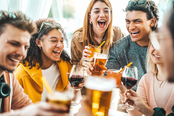 Multiracial friends celebrating party drinking cocktails at bar restaurant - Young people having...