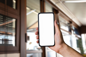 Man holding smartphone with blank screen, close-up of hands. Space for text.