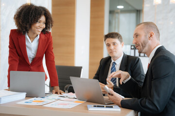 Mature business leader consultant talking to team of diverse colleagues listening to white CEO. Group project manager negotiating in the boardroom at a meeting.