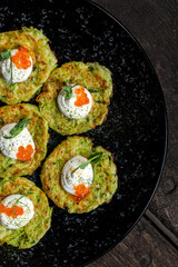 Zucchini fritters with sour cream and red caviar