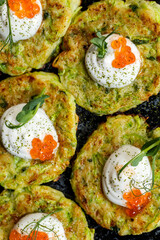 Zucchini fritters with sour cream and red caviar