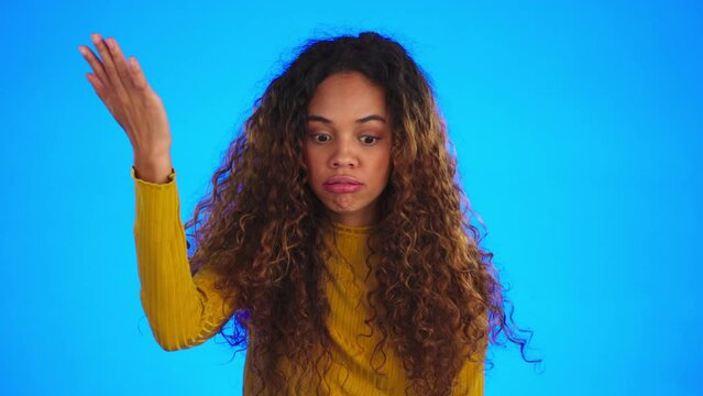 Face, hand and frustrated woman in a studio feeling angry and moody from problem. Facepalm, isolated and blue background of a female using sign language to show dumb with hands gesture from mistake
