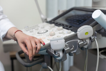 Qualified medical specialist using ultrasound equipment in the clinic