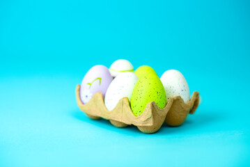 multi-colored painted Easter eggs on a blue background