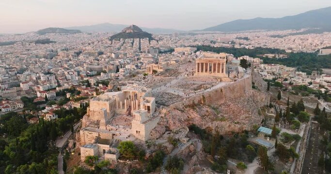 Greece Acropolis city of Athens parthenon symbol of ancient aerial view slide from drone on panorama of residential buildings at sunset summer. Lights sun, lens flare. World Heritage sites. History