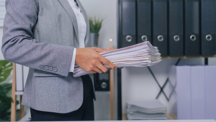 Holding stack of papers, Young confident asia people entrepreneur ceo female business woman broker in suit office worker, help clients.