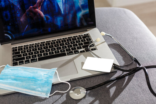 stethoscope, card. Passport, face mask and computer.
