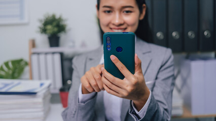 Texting on cellphone, Young confident asia people entrepreneur ceo female business woman broker in suit office worker, help clients.