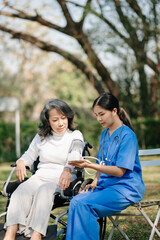 Senior woman being examined by a doctor in background. hospital garden concept..