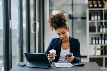 Young attractive African female office worker business suits smiling at camera in office