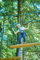 A boy in a rope park. Extreme sports and recreation.