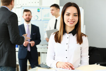 Portrait of a smiling businesswoman in background group of colleagues partners. Joint project and business consultant concept