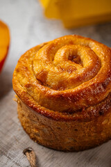 Portion of fresh baked sweet swirl bun roll on serving board