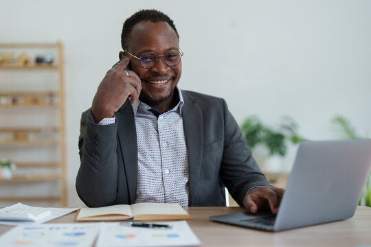 Middle Aged Man American African Using Smart Phone Mobile And Laptop Computer With Planning Working On Financial Document, Tax, Exchange, Accounting And Financial Advisor