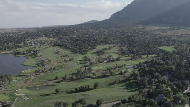 Colorado Country Club Golf Course, with Cheyenne Mountain in the background in Colorado Springs, Colorado. Aerial 4K drone video in the Rocky Mountains. 