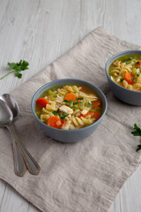 Homemade Chicken Noodle Soup in a Bowl, side view.