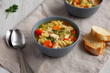 Homemade Chicken Noodle Soup in a Bowl, side view.