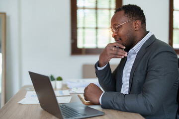 middle aged man American African business man holding computer laptop with hands up in winner is gesture, Happy to be successful celebrating achievement success