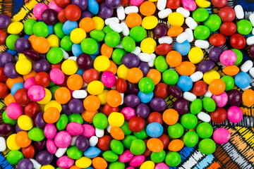 Skittles candy on the colorful table, colorful sweet candy