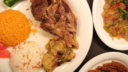 Beef breast ribs served with rice and appetizers on a serving plate
