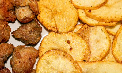 Homemade potato chips with meat, fried in oil.Background of potato chips with meat.