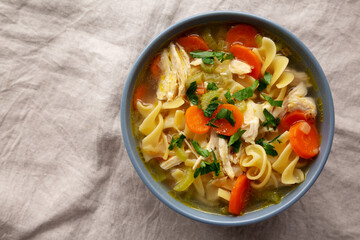 Homemade Chicken Noodle Soup in a Bowl, top view. Flat lay, overhead, from above. Copy space.