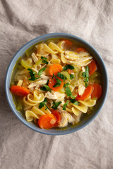 Homemade Chicken Noodle Soup in a Bowl, top view. Flat lay, overhead, from above.