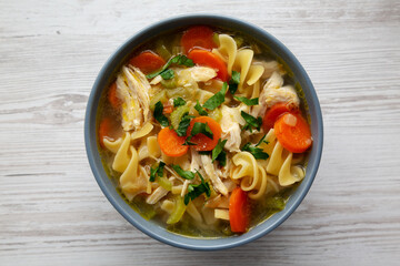 Homemade Chicken Noodle Soup in a Bowl, top view. Flat lay, overhead, from above.