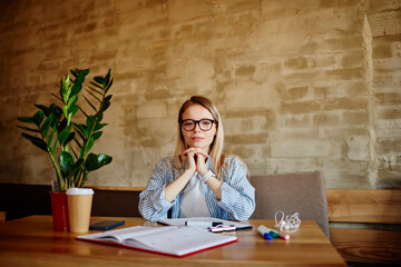 Young woman studying in cafeteria