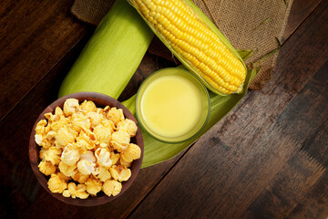 Caramel Popcorn and Fresh Corn on the old wooden table