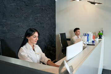 Man and woman working at the table in salon