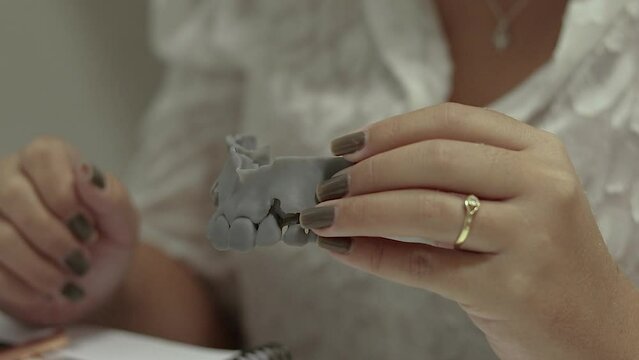 Woman handing a dental impression