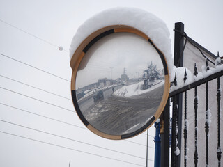 Driveway mirror. A convex mirror on the street. Hump mirror for blind spots in city traffic.
