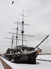 The large sailing ship Flying Dutchman, which now houses a restaurant, on Mytninskaya Embankment. Against the background of the sky with clouds in St. Petersburg.