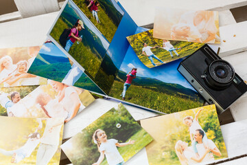 Fototapeta na wymiar printed photos of family summer vacation lying on desk.