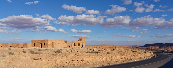 Old, crumbling kasbah on the side of the road in the mountains of Morocco.