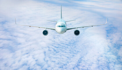 White passenger airplane flying in the sky amazing clouds in the background - Travel by air transport