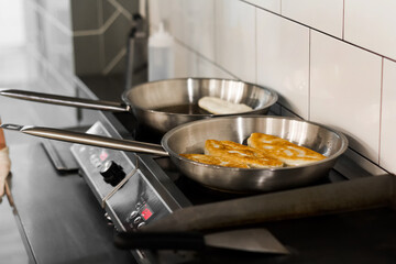 fried pies with potatoes, peas and cabbage in a skillet in oil